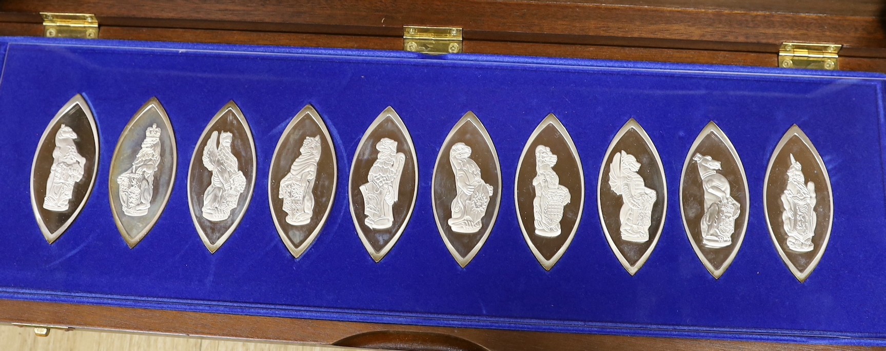 Four assorted modern cased silver ingot sets, to include 'The Beauty of Britain's Churches', 47oz, 'The Official World Wildlife Collection', 49oz, 'The Queens Beasts', 15oz and 'The Royal Standards' 3.5oz